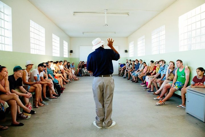 Ex-Robben Island political prisoner briefing tourists about Robben Island history.